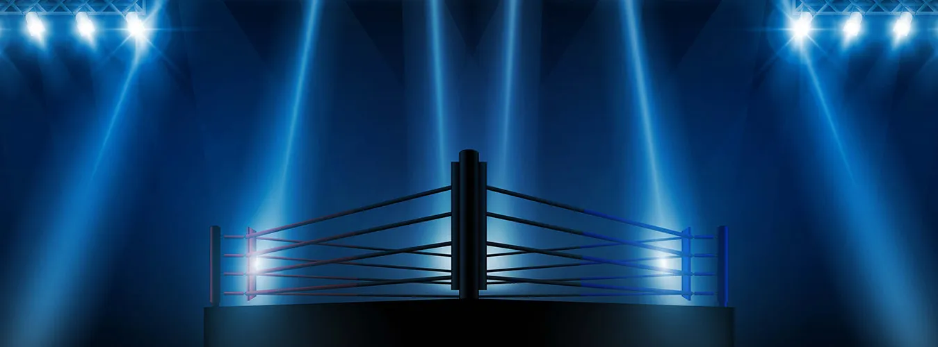 Empty boxing ring illuminated by dramatic blue spotlights in a dark arena